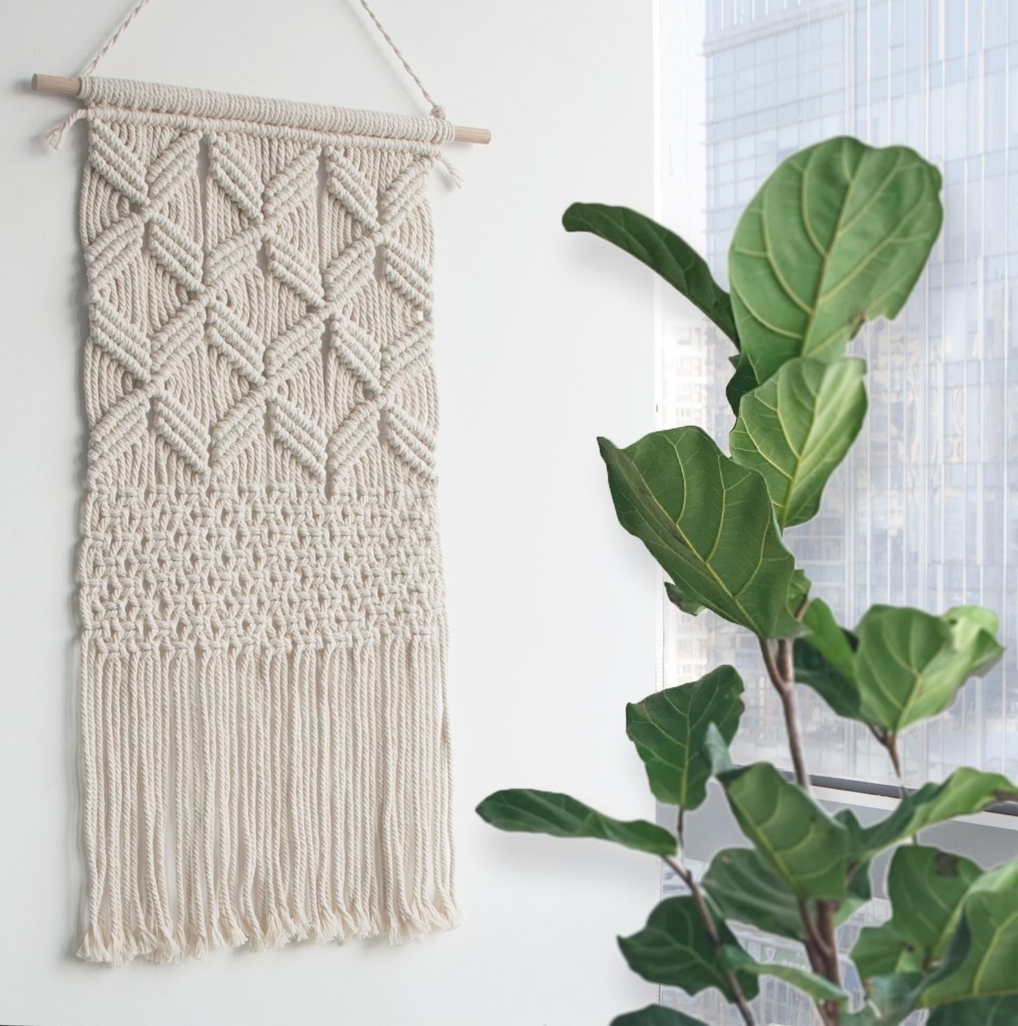 The macrame tapestry hanging on a wall. 
