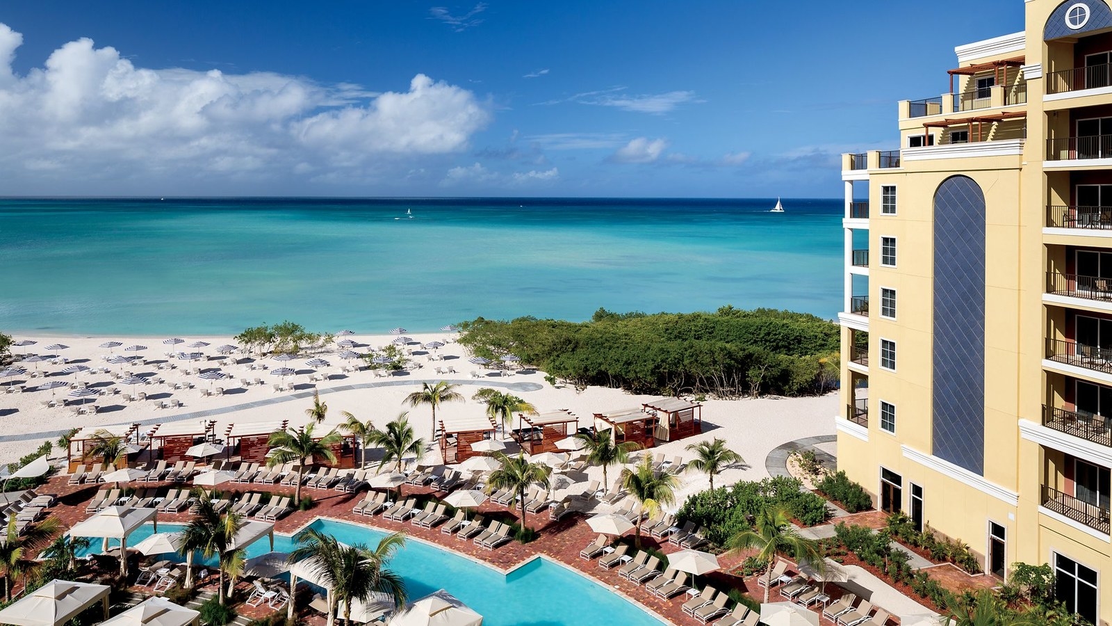 Located just steps from the soft white sands of Aruba’s Palm Beach, the luxurious The Ritz Carlton, Aruba is the perfect place to discover all of Aruba's charm and magic. All of the hotel's rooms and suites feature private balconies overlooking the Caribbean Sea, and other amenities include four dining outlets, a luxurious spa, two swimming pools, and a 24-hour casino.