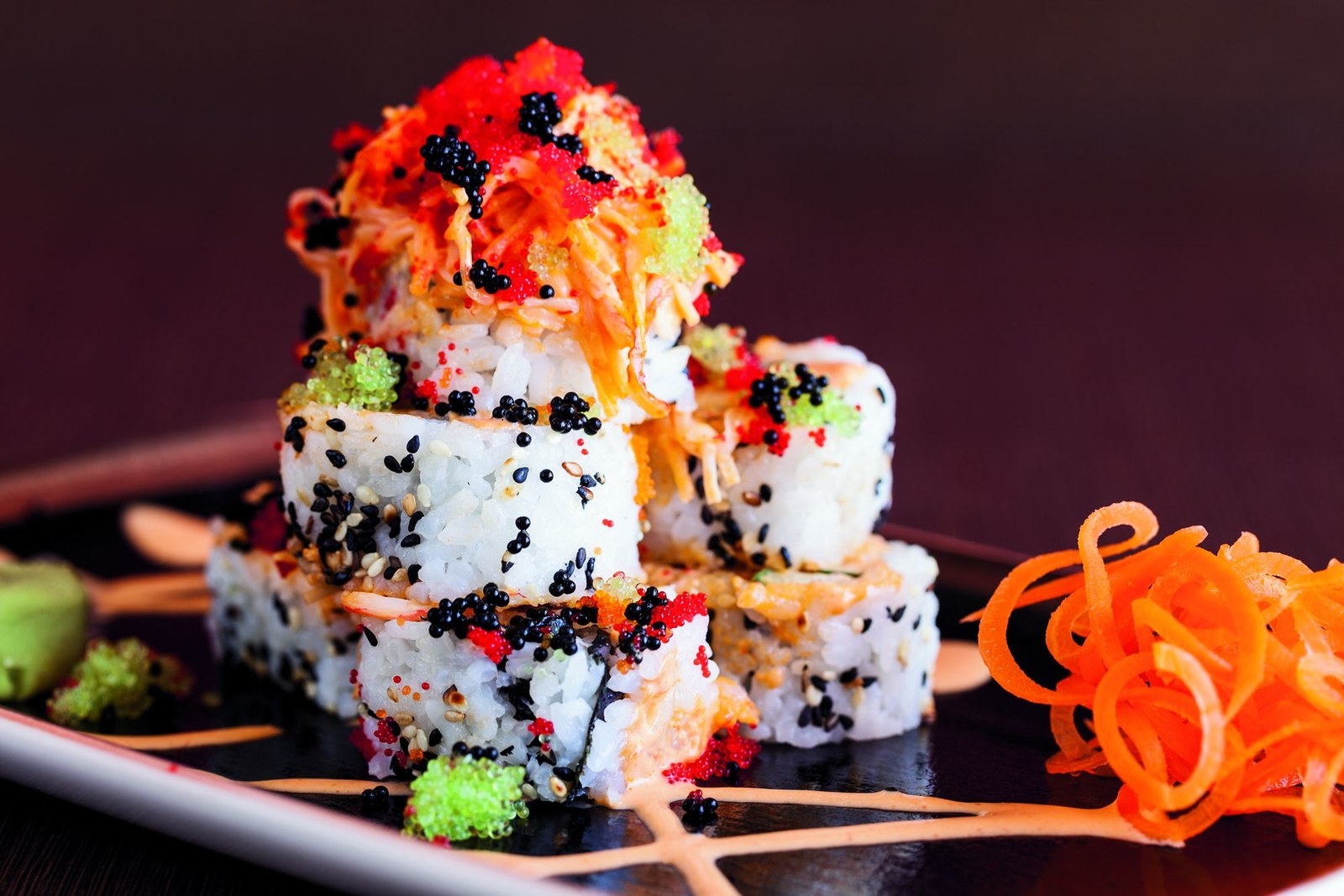 Divi Bar & Lounge is the perfect place for snacks, cocktails, and over-the-top rolls while enjoying the beautiful sunset along Palm Beach. Selection of small bites include marinated olives, cheese board, and pastechis (local empanadas), while the specialty rolls range from Volcano Roll (crunchy bonito furikake, kanikama salad, shrimp tempura, avocado, spicy salmon, black tobiko, sriracha) to Santo Largo (hamachi, cucumber, scallion topped with red snapper ceviche, spicy king crab, spicy mayo and sriracha sauce)