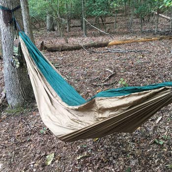 A reviewer photo of two people zipped into the hhammock