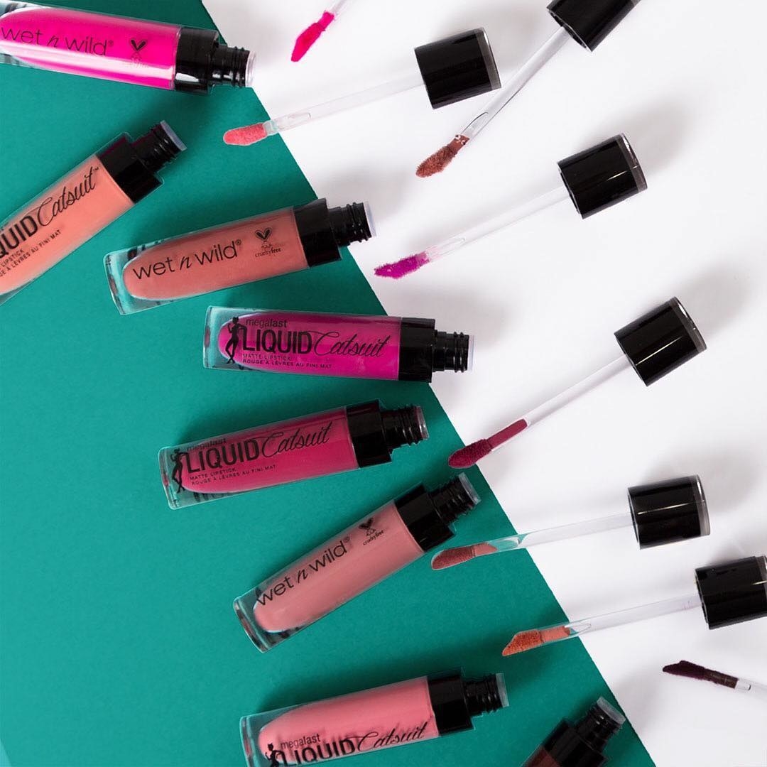 An assortment of the Wet n Wild lipsticks in various bright and subdued colors, all open and showing the doefoot applicator