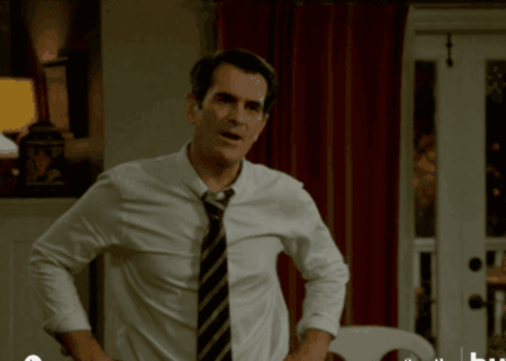 Phil Dunphy from &quot;Modern Family&quot; smiling and raising his fists in triumph
