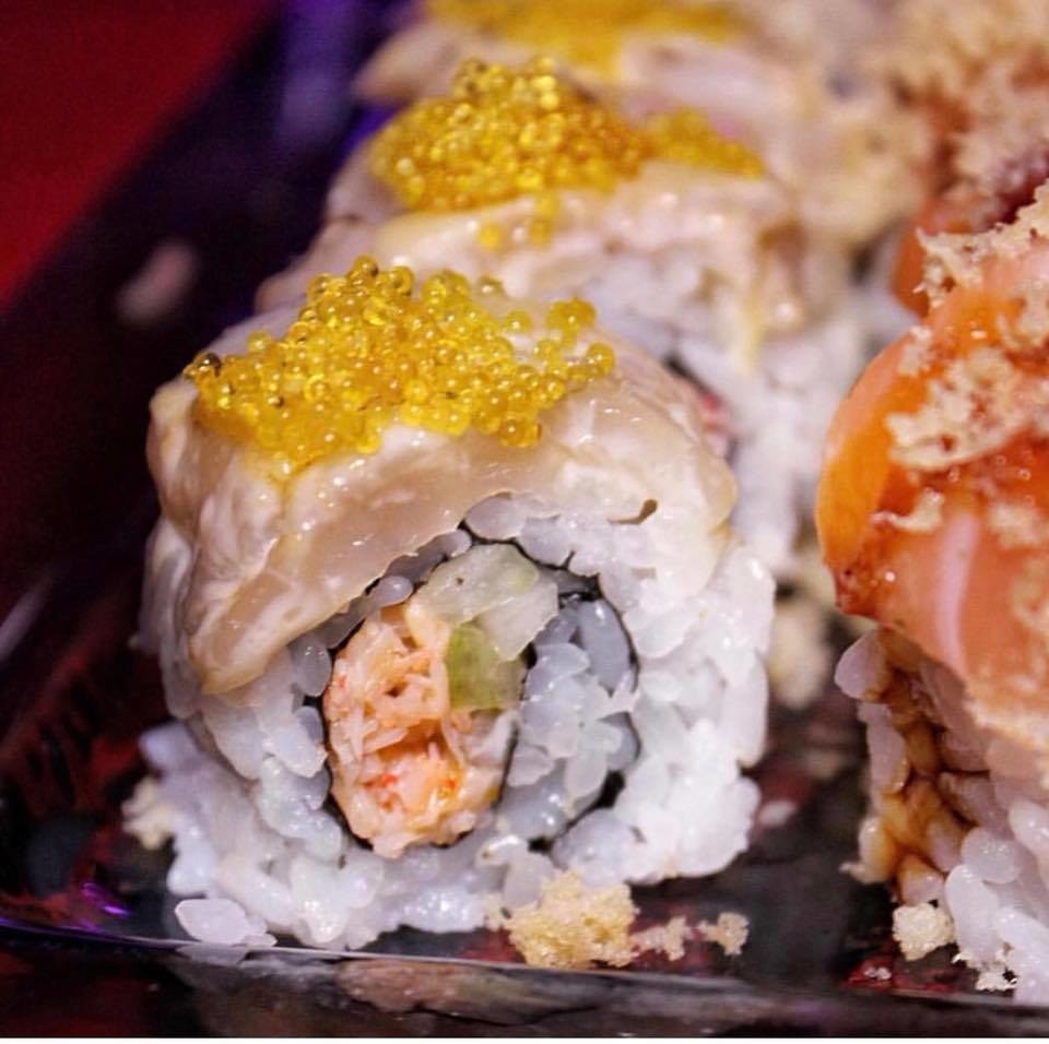 There are many specialty sushi rolls at Sushi Roxx, including Marilyn Monroe. Inside the roll are spicy snow crab, cucumber, and crunchy tempura bits, topped with seared scallop, miso aioli, and yuzu tobiko.