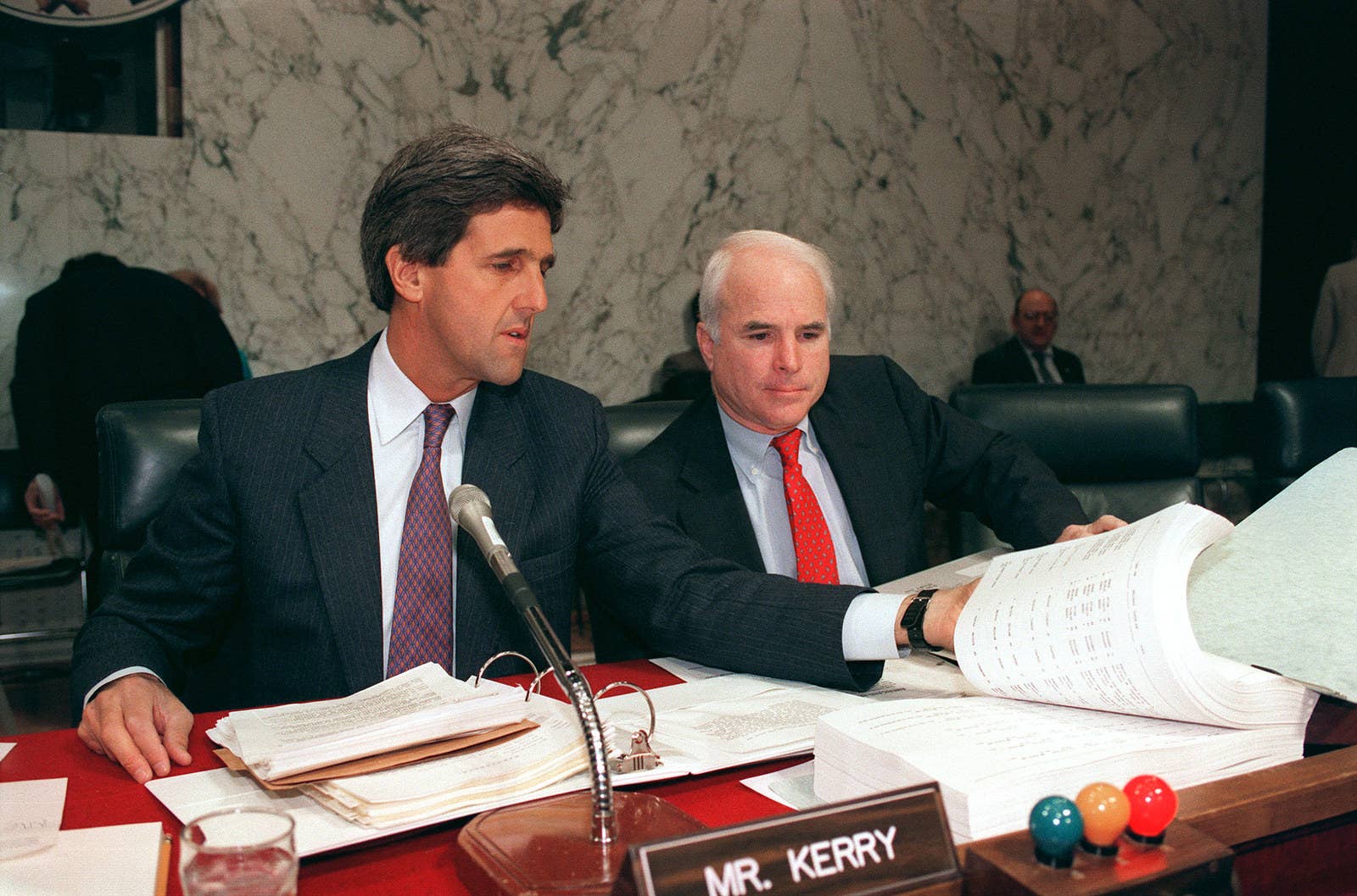 Sen. John Kerry, who received three Purple Hearts while serving in Vietnam, and Sen. John McCain, who was a POW in Vietnam from 1967 to 1973, examine a book containing the names of the &quot;unaccounted for&quot; soldiers who served in the Vietnam War, on June 24, 1992.