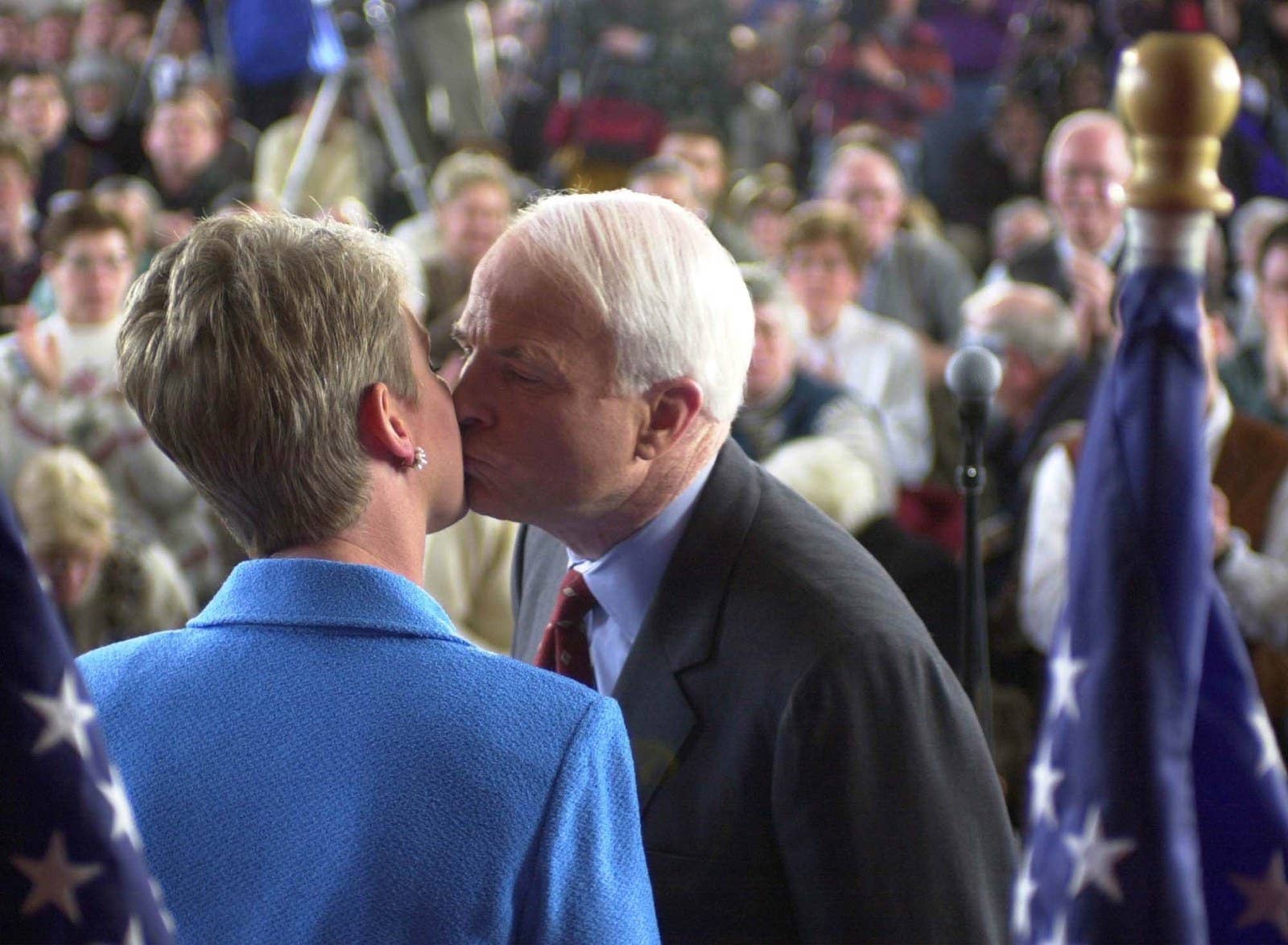 McCain, then a Republican presidential hopeful, gives his wife Cindy a kiss prior to his final town meeting on Jan. 30, 2000, in Peterborough, New Hampshire.