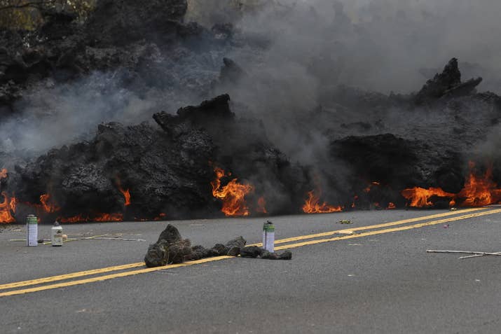 Lava burns near offerings to the volcano goddess in Leilani Estates on Saturday, May 5