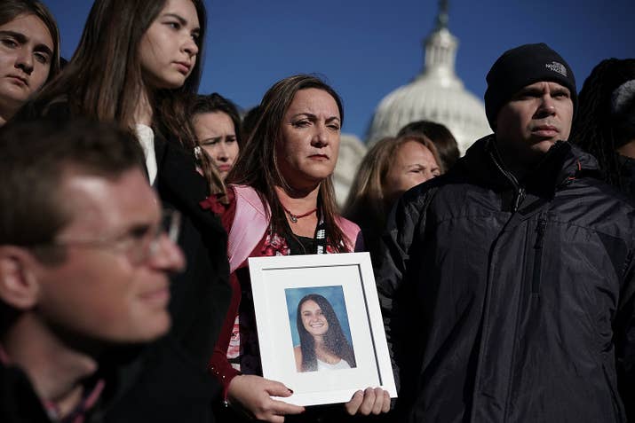 Lori Alhadeff holding a picture of their daughter Alyssa Alhadeff next to her husband Ilan Alhadeff.
