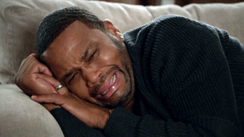 Anthony Anderson as Dre from Black-ish sobbing on the couch