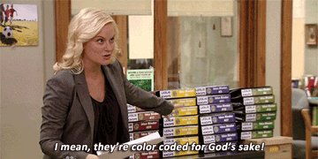 Amy Poehler from Parks and Rec pointing to stacks of binders and saying &quot;I mean, they&#x27;re color coded, for god&#x27;s sake!&quot;