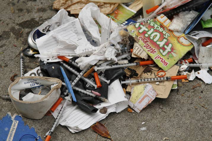 Syringes are scattered in the remains of a tent city along Division Street in San Francisco.