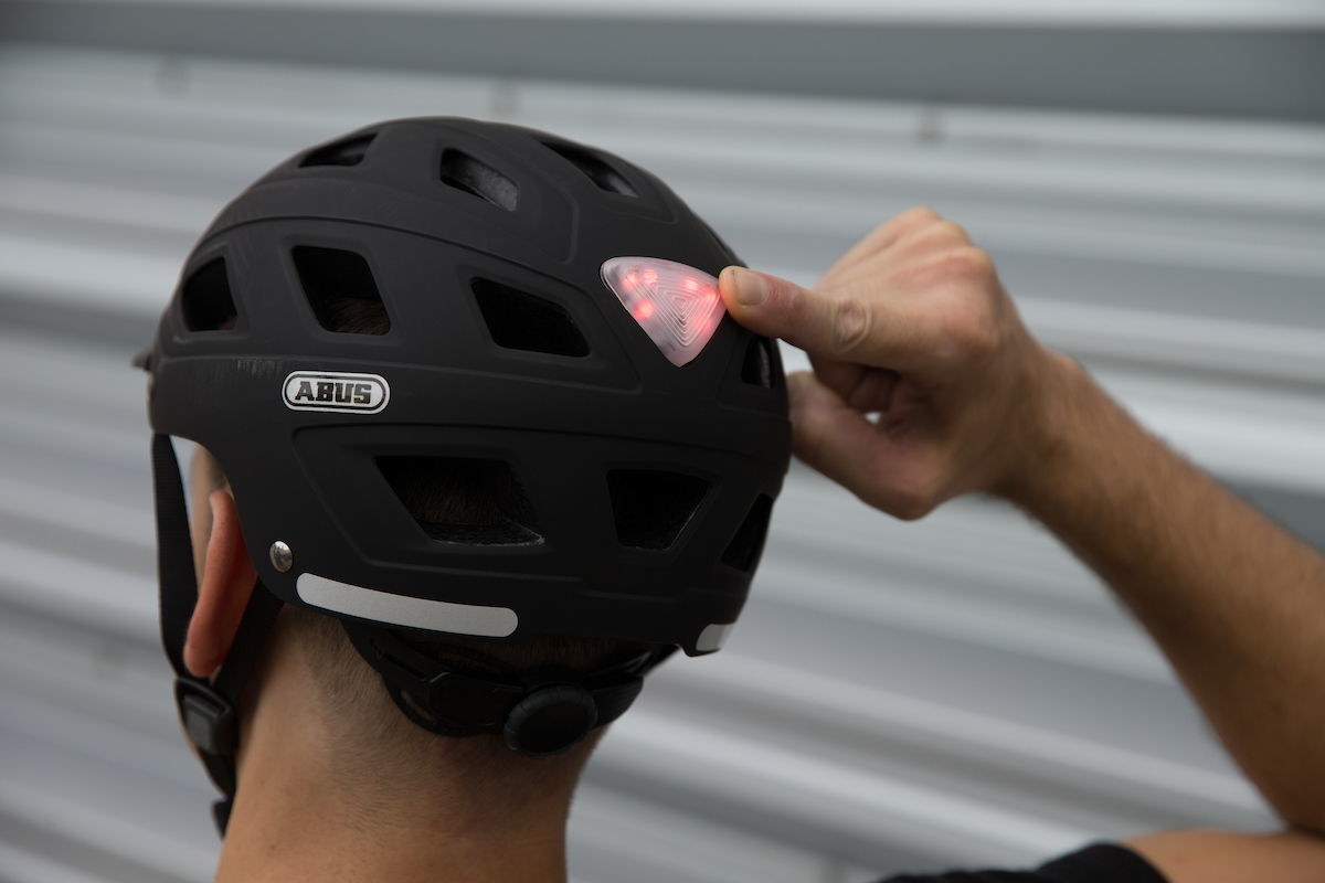 Nothing compares to the feel of a summer breeze rushing past as you pedal by on your bike. The ABUS Hyban helmet offers 18 huge air vents keep you cool and comfortable while a wide range of color options let every rider find a look that suits their individual style. Additional features of this premium helmet include an integrated LED light, rain cover, and magnetic chin strap closure for the utmost safety and comfort.