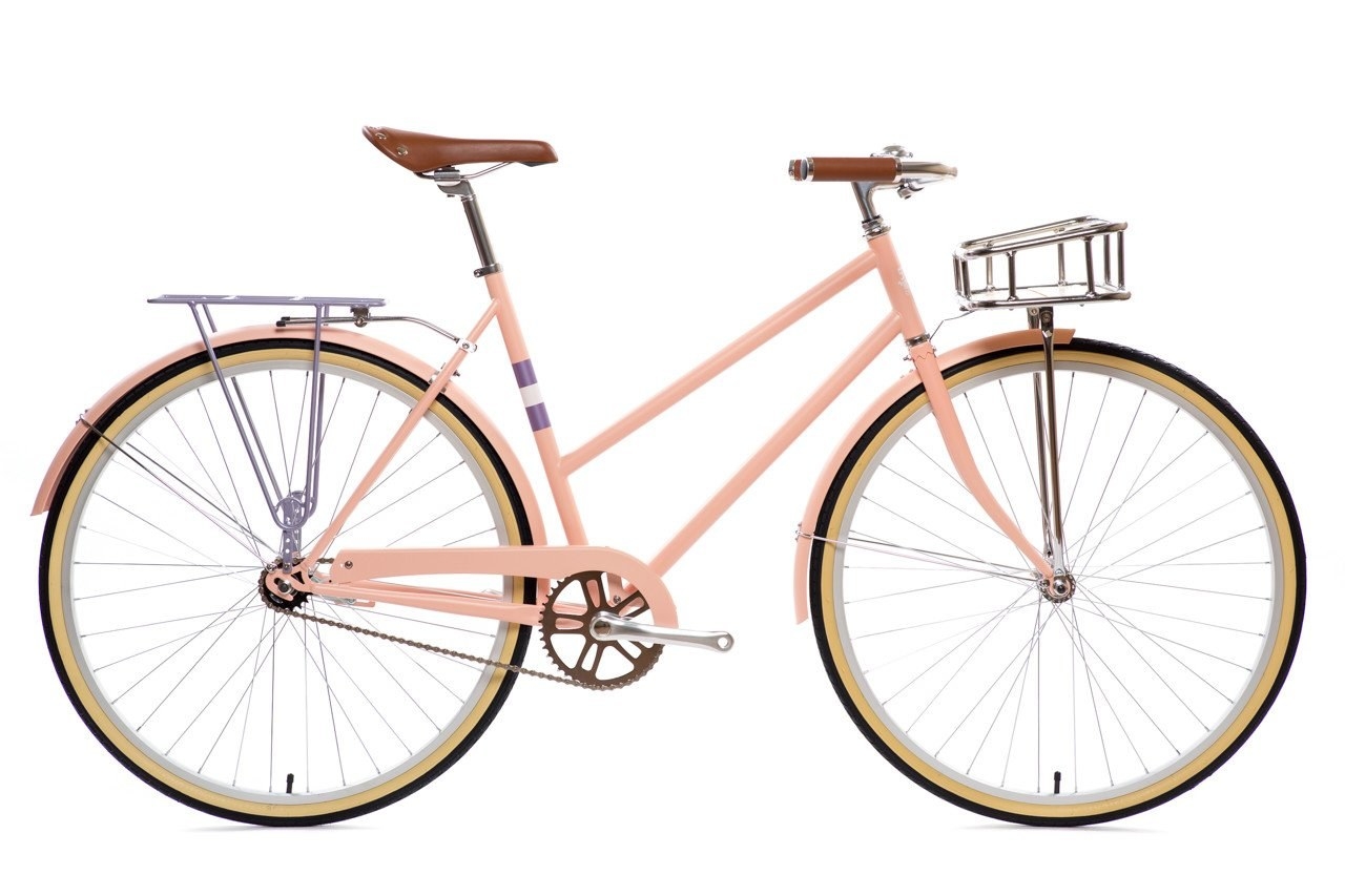 Be the envy on the road with this beautiful commuter bike from State Bicycle Co. The Adrian Deluxe, part of City Bike series, is lined with matte pink frame with lavender accents. The smooth bike cruises with either 1-speed or 3-speed option, and comes with bonus features like a matching-rear pannier rack, front basket, and bell.