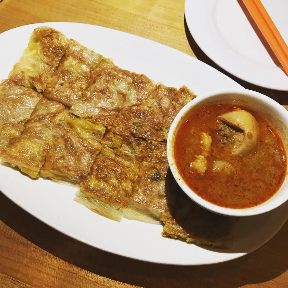 Roti, or flatbread made from stoneground wholemeal flour, is filled with spiced minced chicken, eggs, and onions, and lightly pan-fried on the griddle for crispy exterior. The roti is served with curry potato chicken sauce.