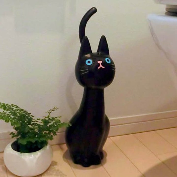 plastic cat next to toilet 