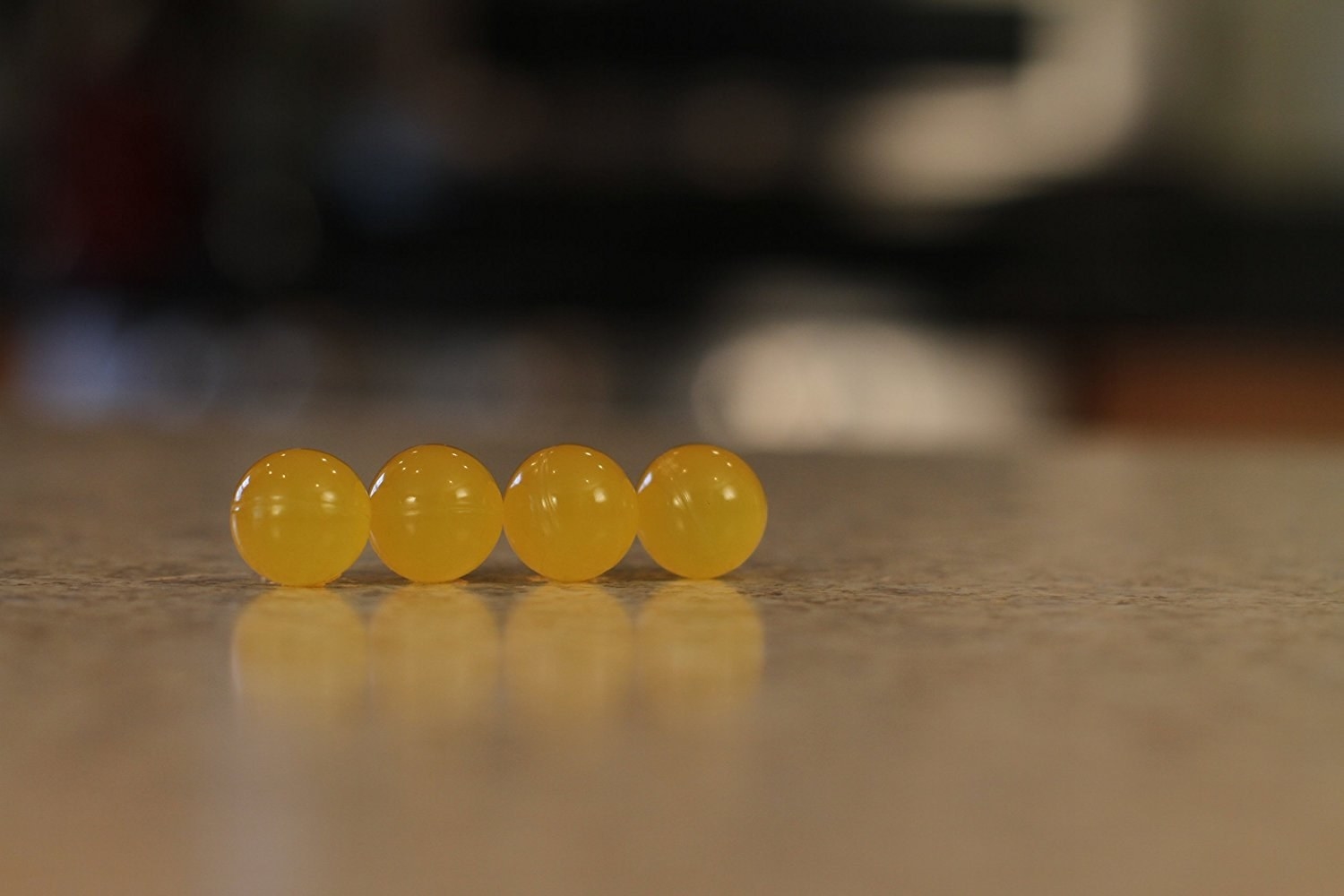 four of the yellow disposer fresher balls on a kitchen countertop