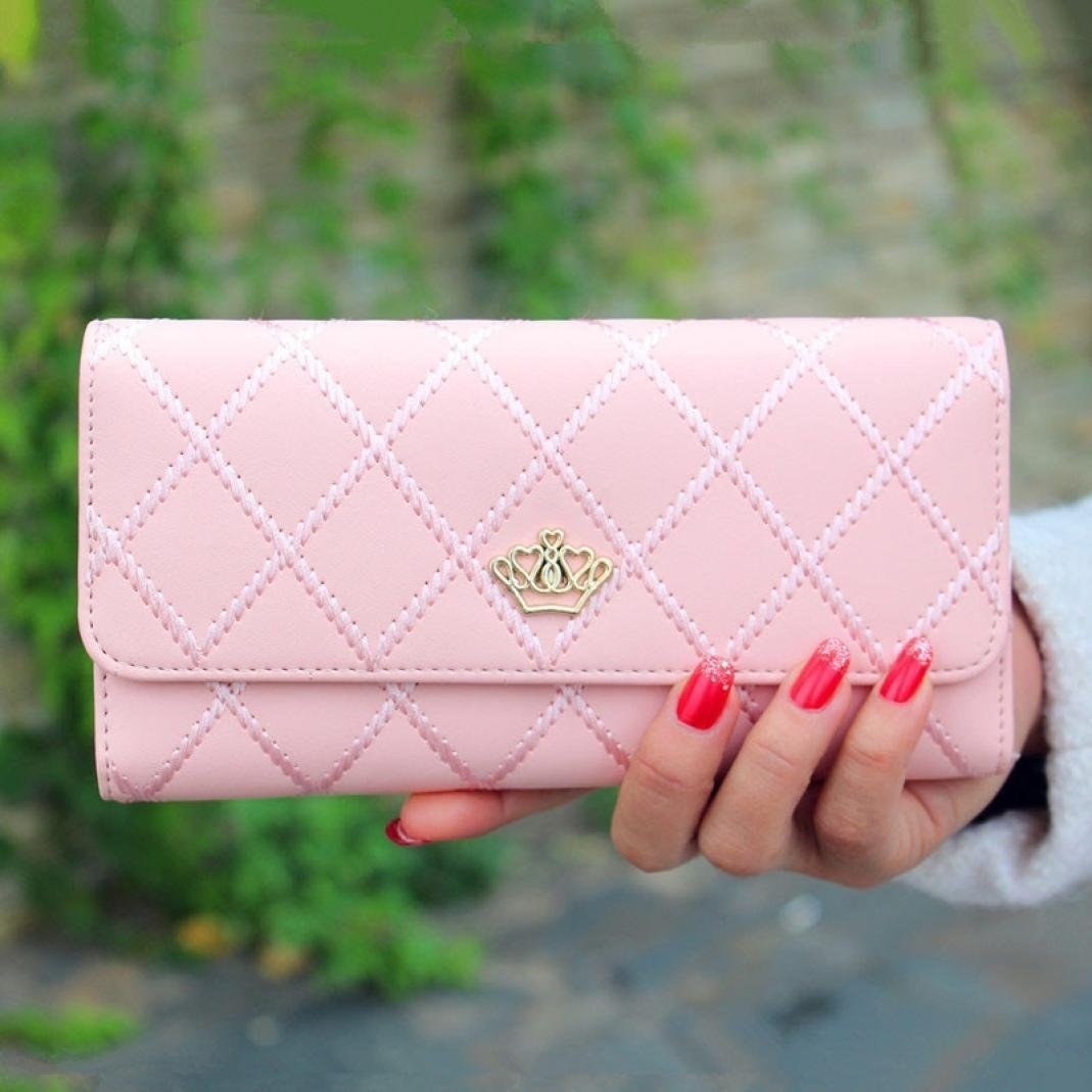 Promising review: "This wallet is so beautiful! It's a perfect size, the details are gorgeous, and it truly has the look of a high-end wallet. I got the light pink one, and I get compliment after compliment on this wallet even while in the high-end stores. Nicely made. I've had this for four months, and it is holding up perfectly! :-)" —A RGet it from Amazon for $8.85+ (available in six colors).