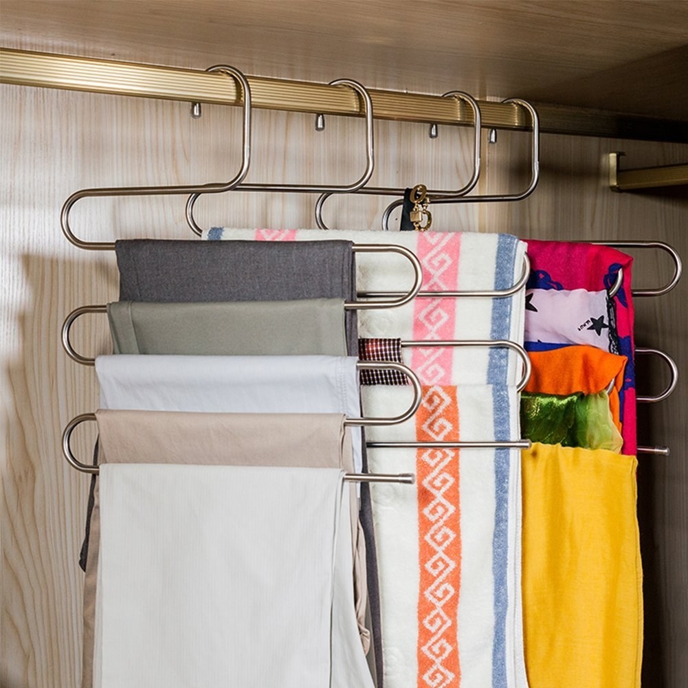 The hangers; they look like three layered es-es stacked on top of each other and stretched out, so the top, middle, and bottom of each es is flat. Folded pants, towels, and scarves are on each flat part