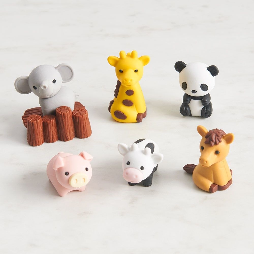 erasers that look like an elephant, giraffe, panda, pig, cow, horse, and stump