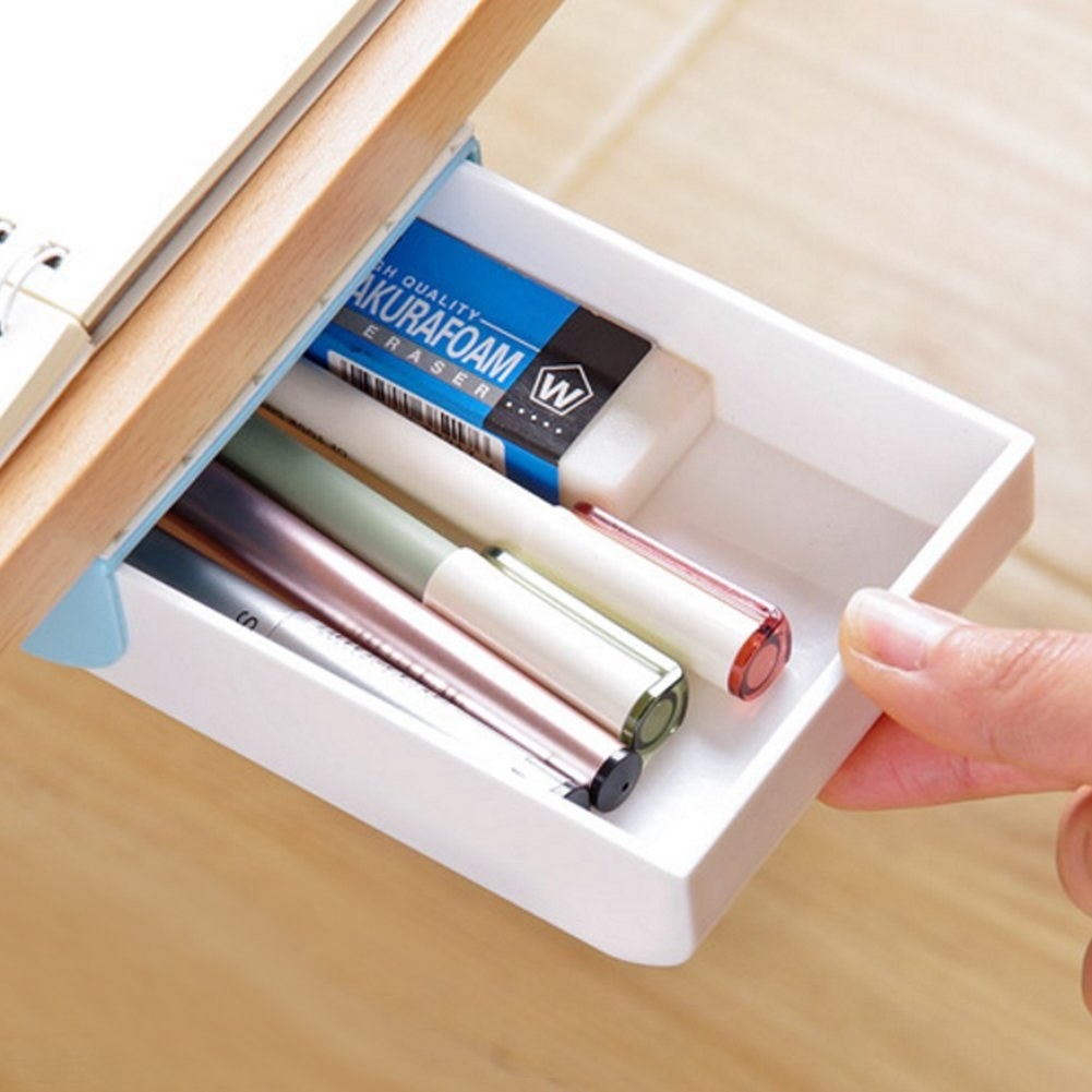 mini plastic drawer that attaches to bottom of desk and can hold about four pens and an eraser