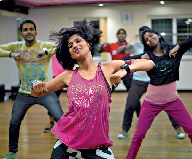 three people dancing in a dance studio