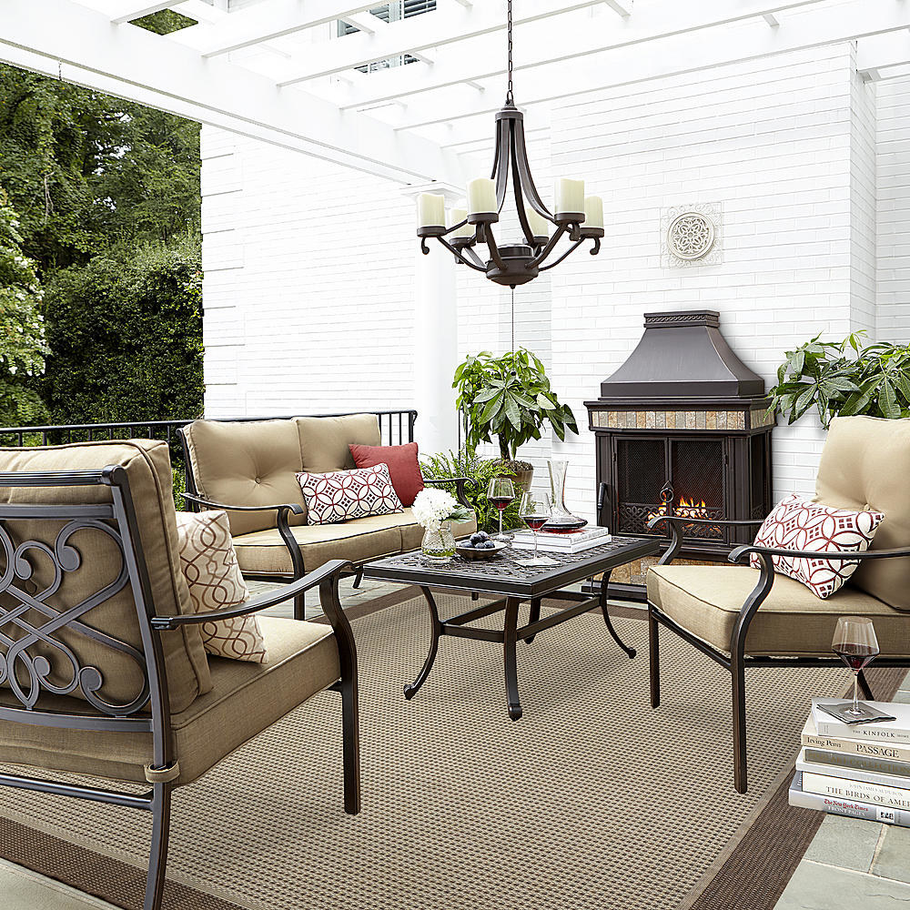the four-piece seating set by a fireplace outside