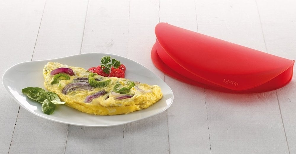 The red silicone omelet maker next to a veggie omelet