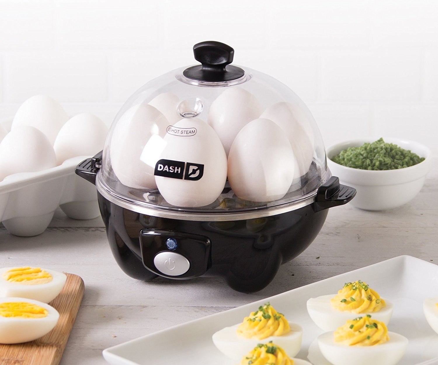 The egg cooker with six eggs in it, plus a plate of deviled eggs