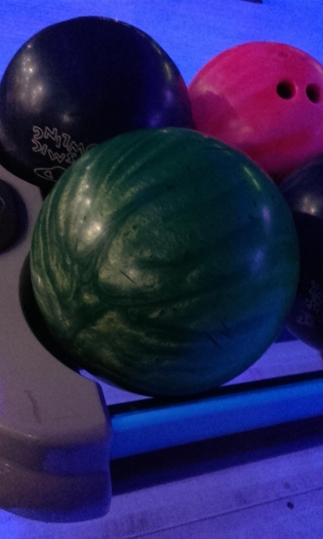 A bowling ball that looks sort of like a whole watermelon