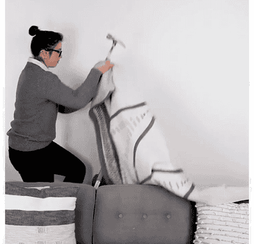gif of person hanging a tapestry