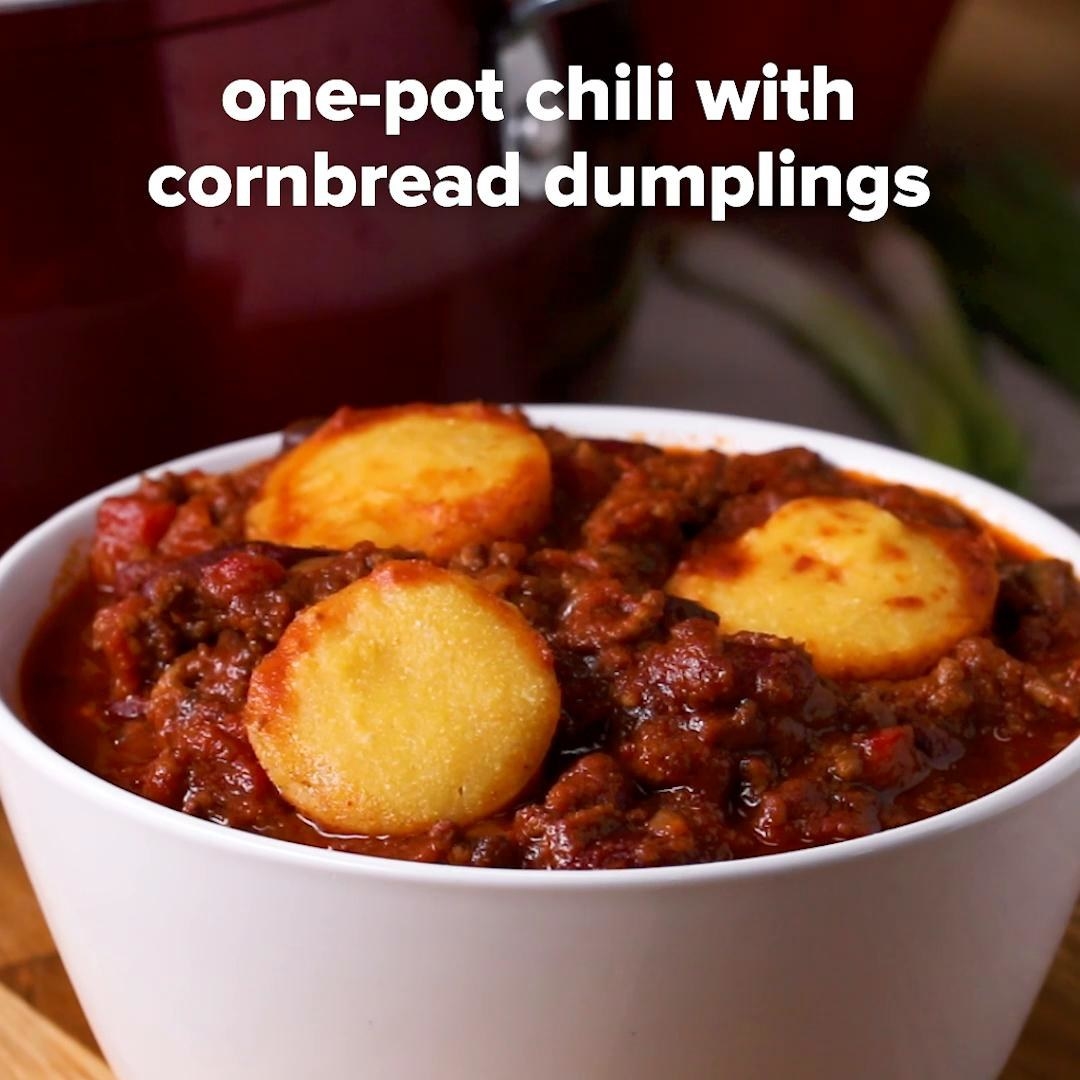 A bowl of chili with cornbread dumplings on top