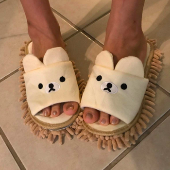 reviewer in open toe cream and tan slippers with teddy bear faces and microfiber fringe