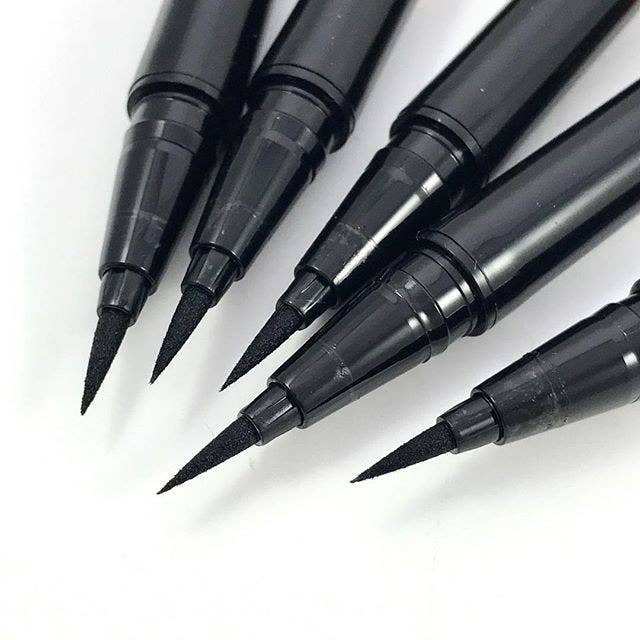a pile of eyeliner pens