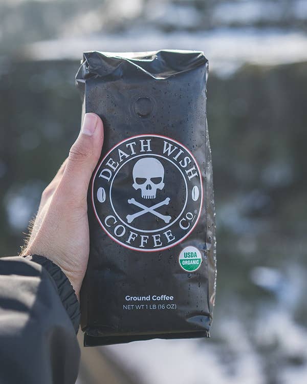 hand holds bag of coffee