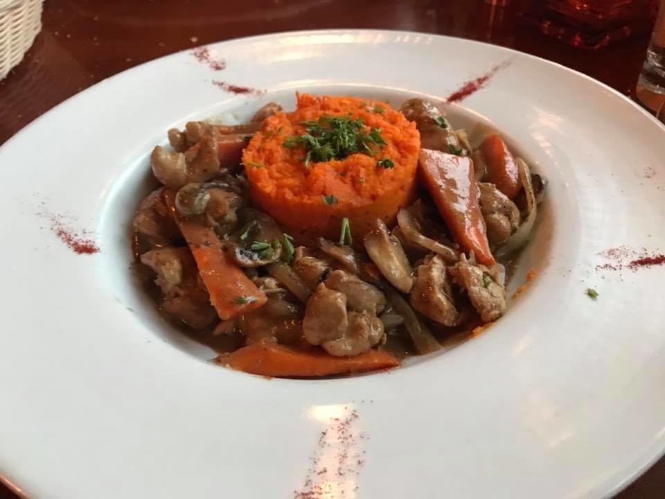 Tender pieces of rabbit thigh and breast is sauteed in buttery, rich brown sauce with variety of vegetables like carrots, onions, and mushroom. In the center is puree of carrot to complement the dish.