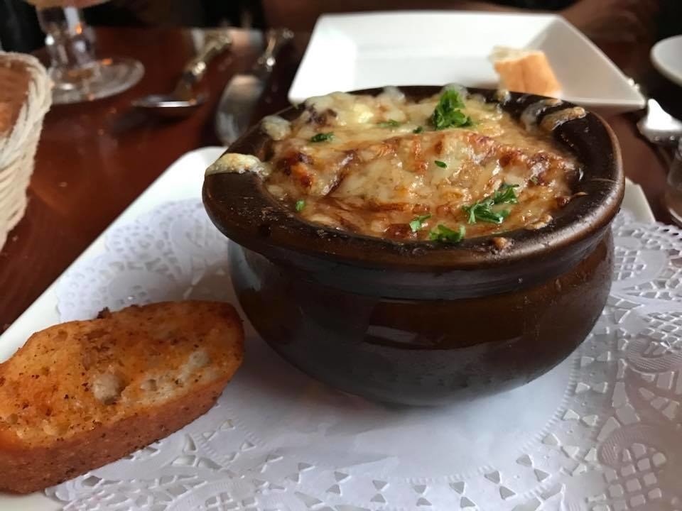 Arguably the best French onion soup in the city, this appetizer is an absolute must. The hearty stock with onions and soaked bread is served gratinéed with generous portion of gooey, melted cheese covering the top. The soup is served with a side of toasted bread.