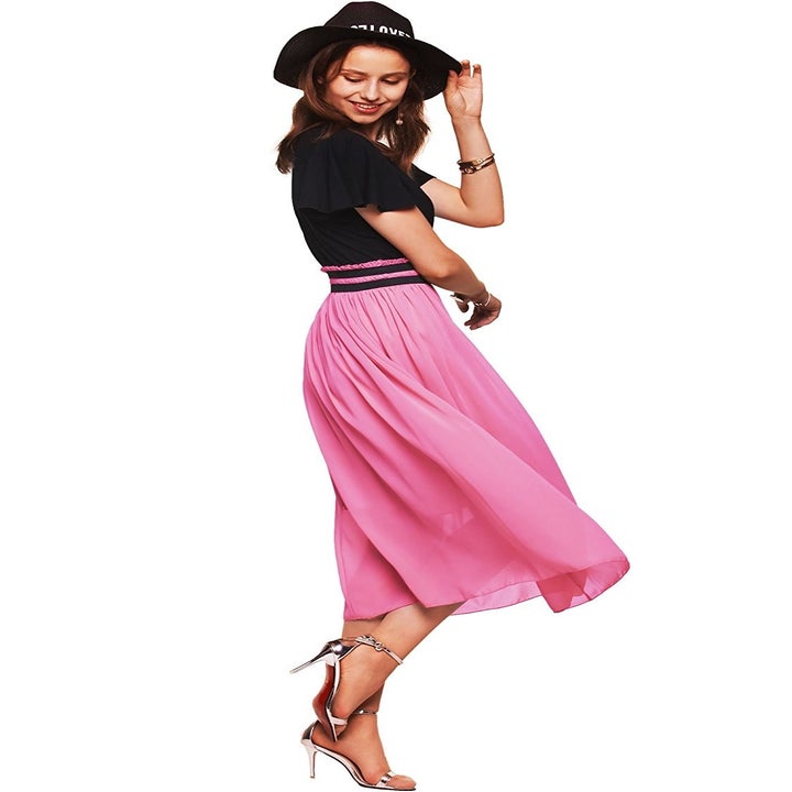 model wears dress in black and hot pink