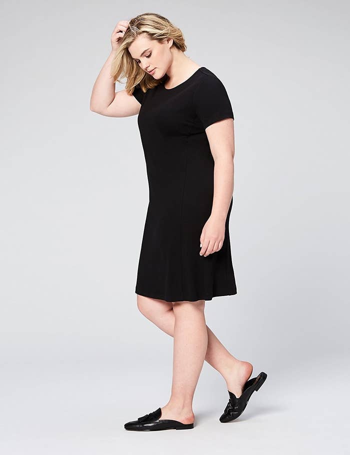 model wears loose midi dress in black 