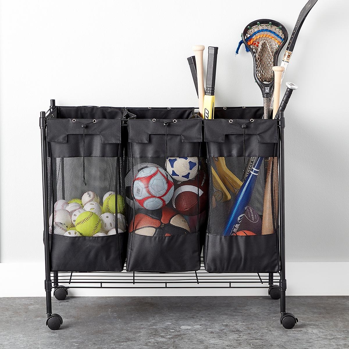 black rolling organizer with three mesh compartments containing sports balls and equipment