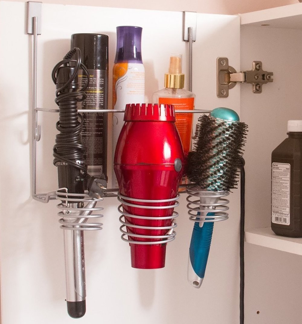 inside a bathroom cabinet door with a silver tone over-the-door organizer for hair tools