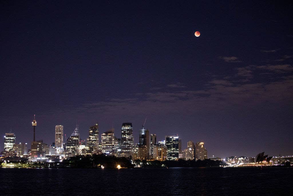 The moon turns red over the Sydney skyline in Australia.