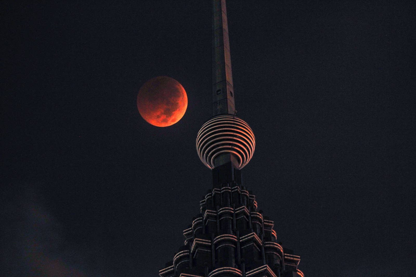 The blood moon is seen above Petronas Twin Tower in Kuala Lumpur, Malaysia.
