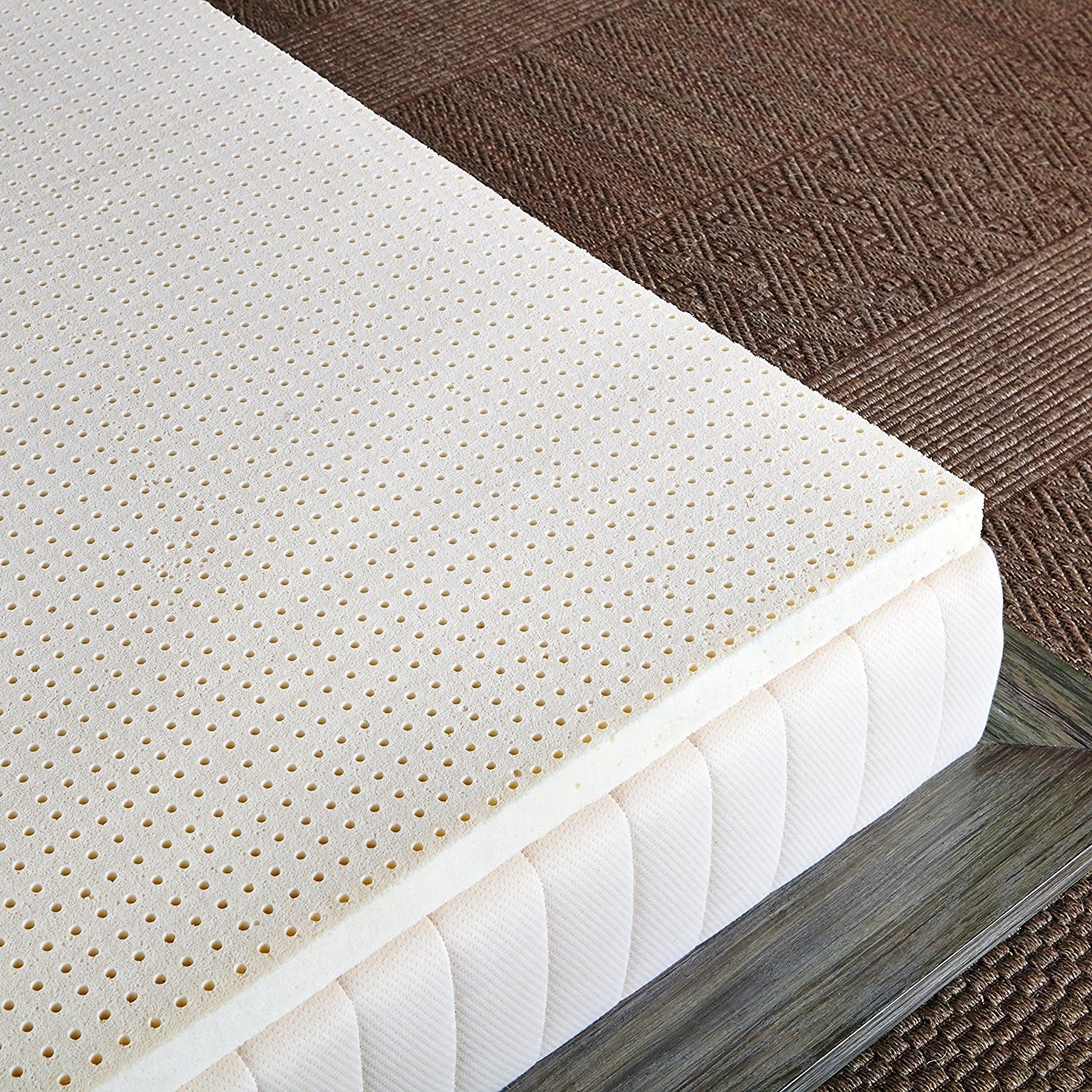 The topper on a mattress — it&#x27;s dotted with a small grid of holes for airflow