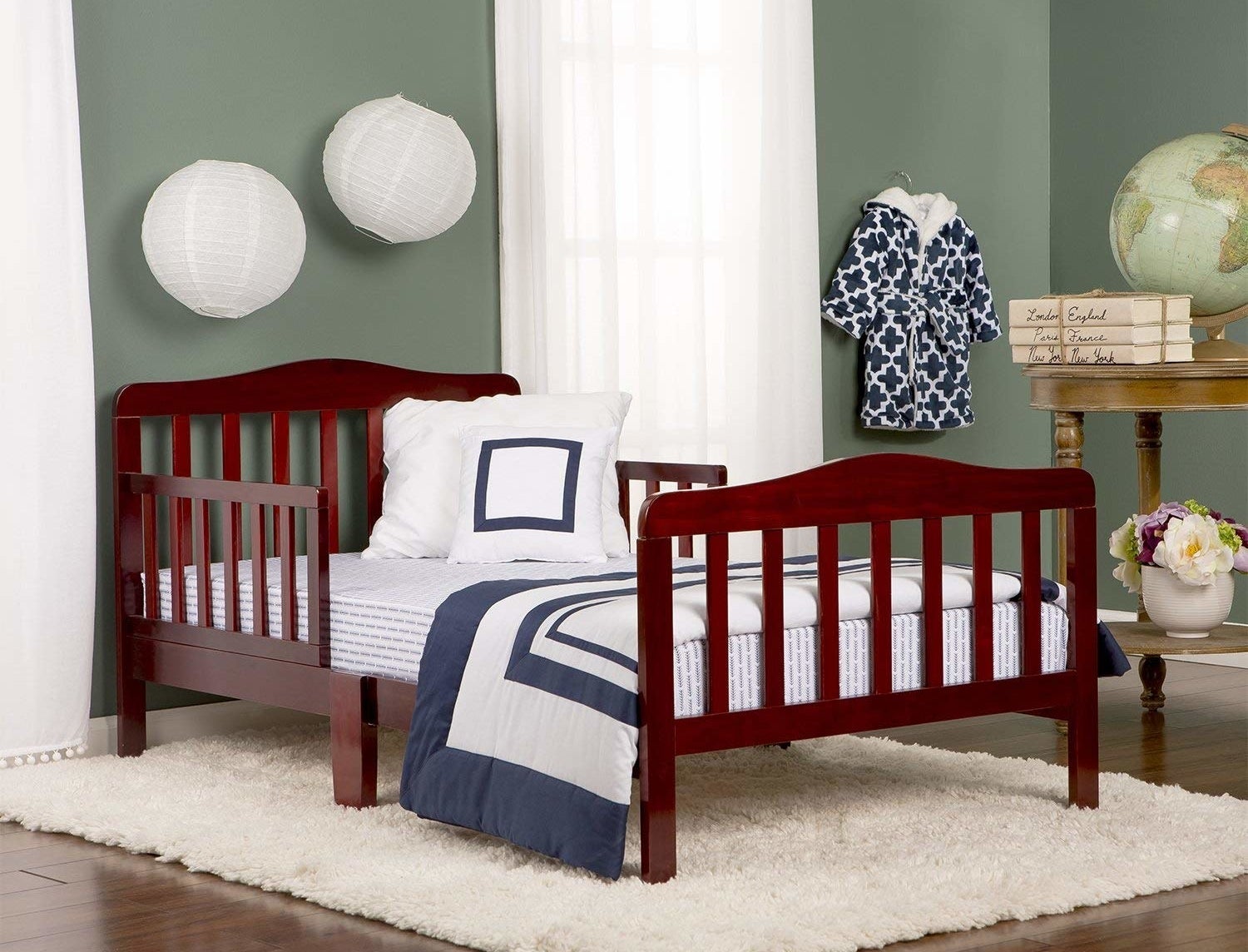 The bed in brown with a head and footboard and rails on either side