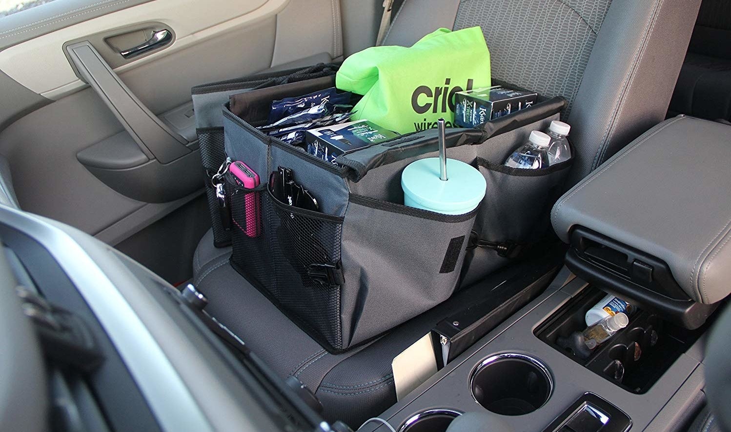 passenger seat of a car with the organizer filled with miscellaneous items on the seat