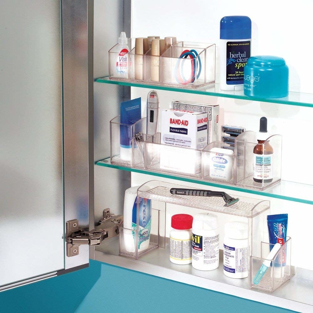 open medicine cabinet with clear organizers on shelves to neatly fit in a lot of items