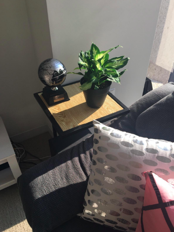 black end table with wooden surface 