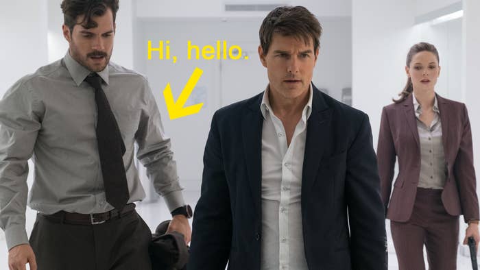 characters in the movie, with a yellow arrow pointing to Henry Cavill&#x27;s arms