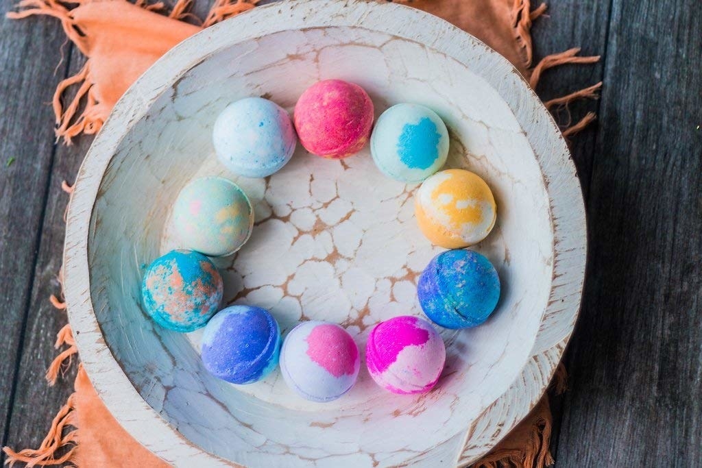 assorted multicolored bath bombs in a bowl