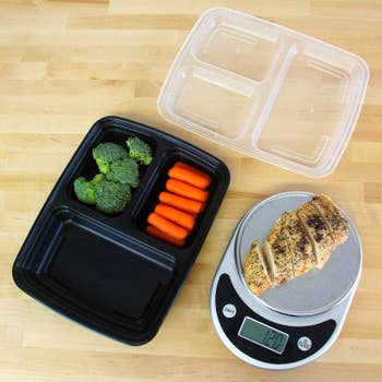 the bento box on a table next to a food scale weighing a piece of chicke