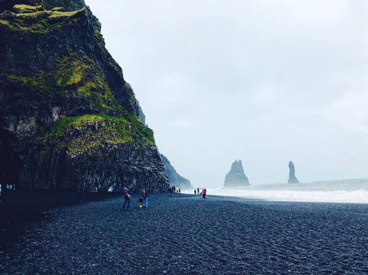 Just a few minutes from the fishing village of Vik sits Reynisfjara Beach, but you won&#x27;t be needing a swimsuit. Here, booming waves from the Atlantic collide with black sandy shores and in the distance, sea stacks shine through the foggy skies.